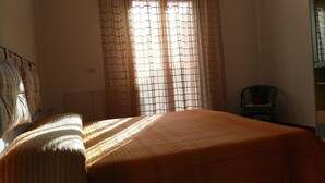 A room with a bed, a chair, and a window with curtains. - Panorama Apartment (Intimate, up to 3 people) (Muravera)