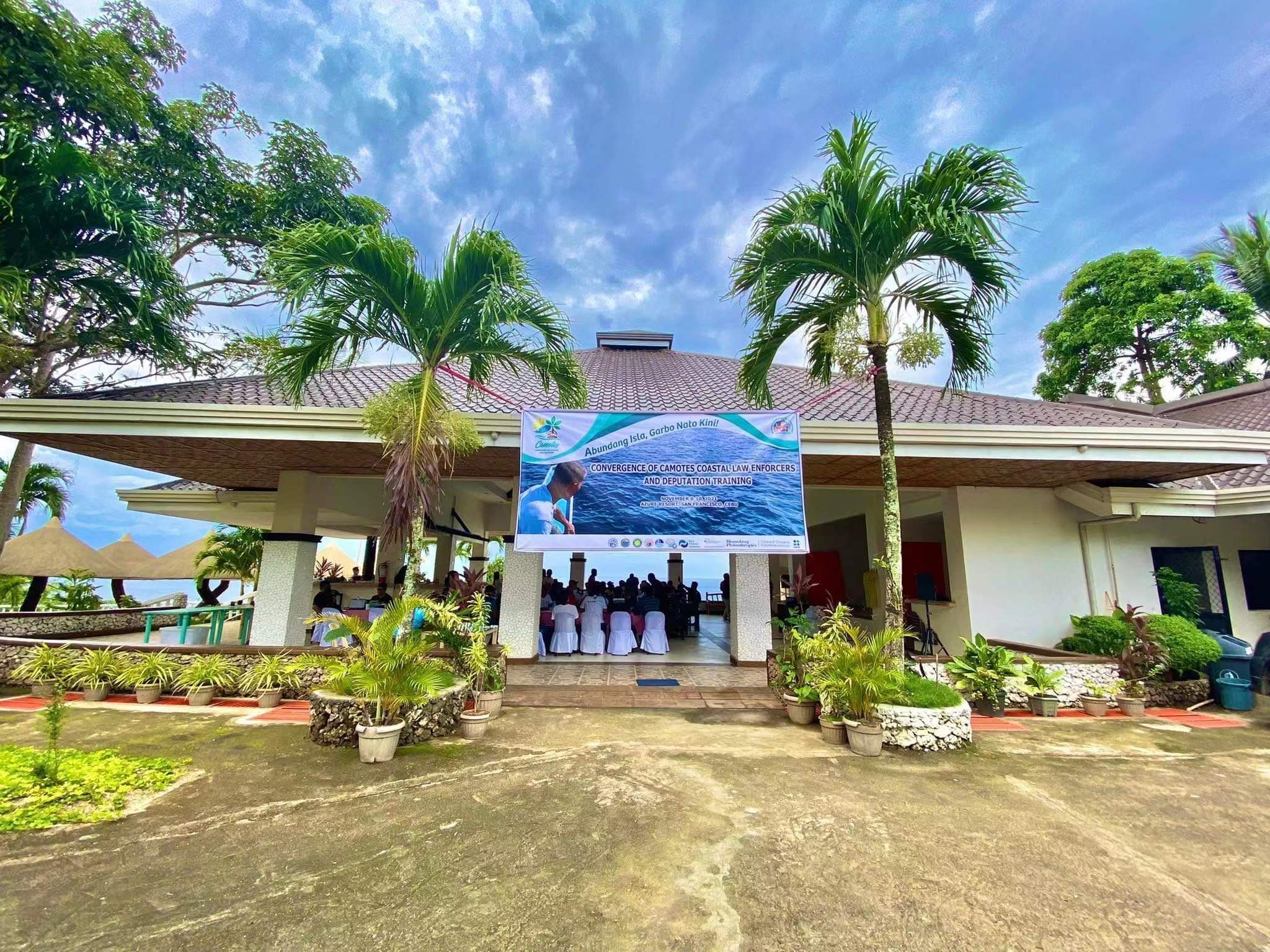 A building with a signboard for a convergence of Camotes Coastal Law Enforcers and deputation training.