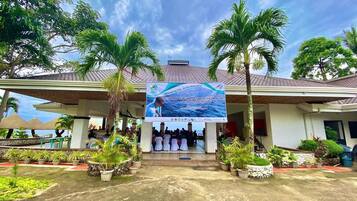 A building with a signboard for a convergence of Camotes Coastal Law Enforcers and deputation training.