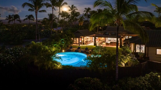 A pool area with a house and lounge chairs, surrounded by palm trees and a night sky. - Beach Walker: Exclusive w/ Pool,Views,Mauna Lani Beach,Golf/Pickleball (Kamuela)