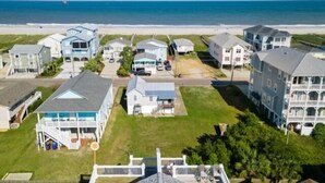 A coastal residential area with houses, a beach, and a clear sky. - Almost Heaven 4 Bedroom Home by RedAwning (Carolina Beach)