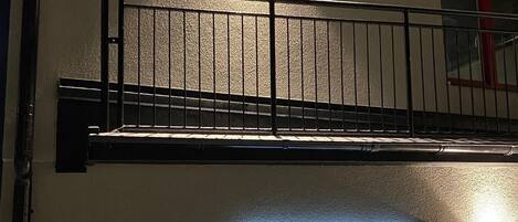 A reception area with a sign indicating 'RECEPTION' and a metal railing above.