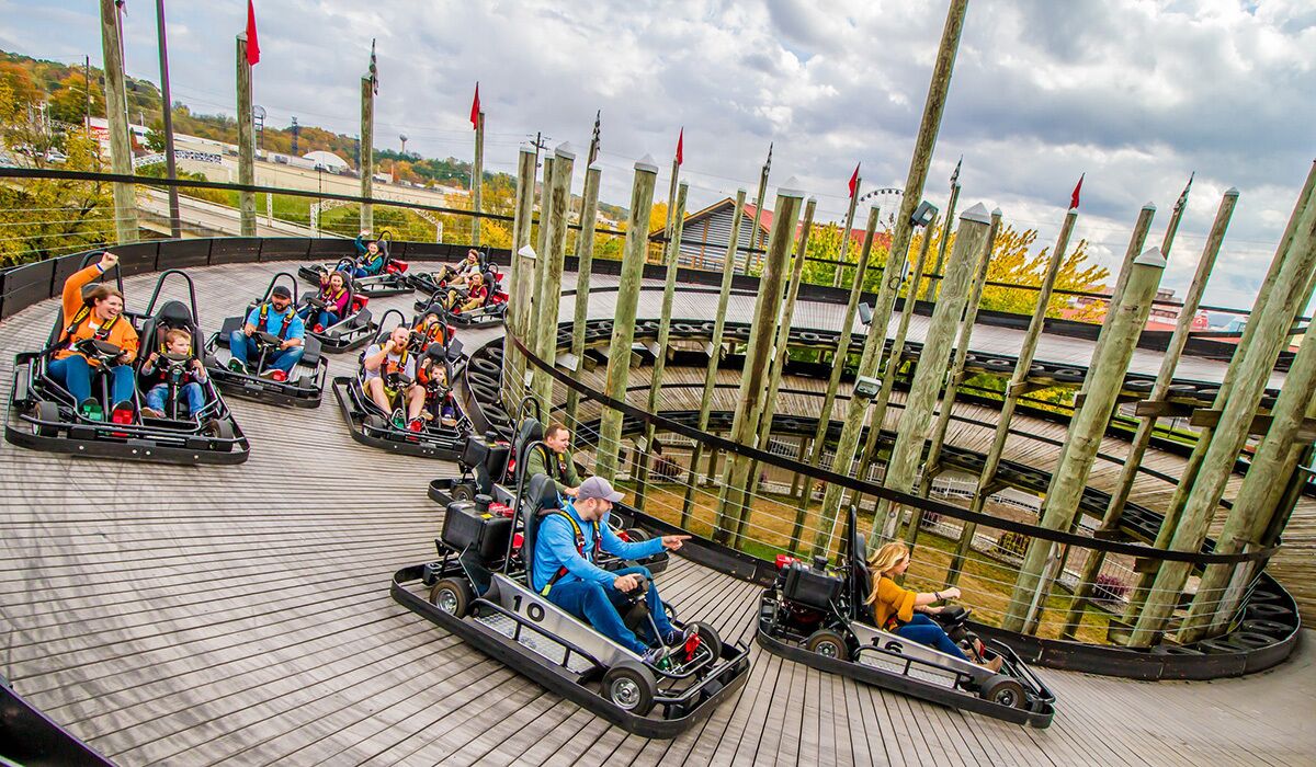 A go-kart track with multiple go-karts and riders.