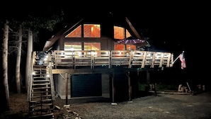 A two-story wooden cabin with a balcony, a garage, and an American flag. - Little Bear Lodge Ponderosa Ca (Springville)