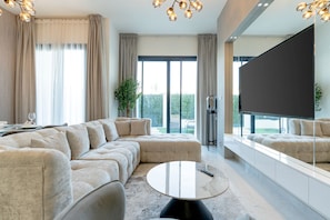 Grand Townhome | Living area | 55-inch Smart TV with cable channels, TV, Netflix - Nasma Luxury Stays- Ras Al Khaimah (Ras Al Khaimah)