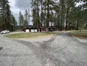 Situated in a forested area, this cabin offers a simple, rustic retreat with a sloped roof and satellite dish.