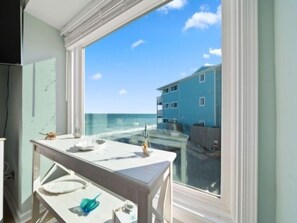 Enjoy ocean views from the large window, with a convenient table and sink area.