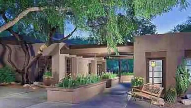 A modern outdoor patio area with a seating arrangement, a large tree, and a well-maintained garden. - Luxury 2B 2B@ Catalina Foothills Resort - Tucson (Tucson)