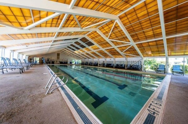 Relax by the pool surrounded by a spacious deck with lounge chairs.