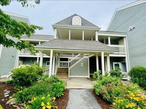 Stunning two-story residence with a covered porch and beautifully manicured garden.