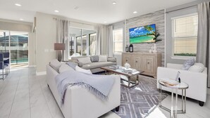 A modern living room with a sofa, coffee table, and TV.