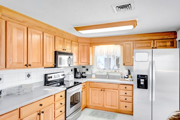 Enjoy cooking in this well-equipped kitchen with a refrigerator, oven, microwave, and dishwasher.