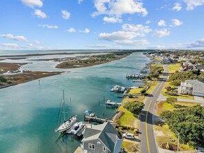 A coastal area with a marina, houses, and a road.