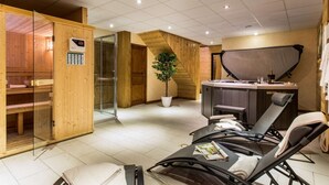 A sauna room with wooden walls, a glass door, and a control panel. - Chalet Snow Dream in le Bettaix (Les Belleville)
