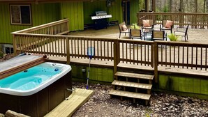 A wooden deck with outdoor seating, a hot tub, and a barbecue grill. - Unique Octagon Ski Lodge in heart of Rib Mountain State Park with hot tub (Wausau)