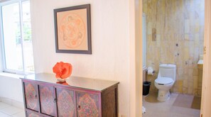 A bathroom with a toilet, a sink, and a cabinet. - Condo Palau by Kivoya (Nuevo Nayarit)