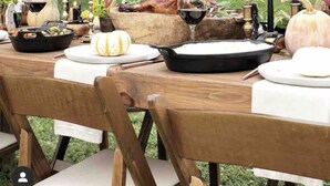 A dining table set outdoors with a house in the background. - The Colonial Farmhouse with Private Boat Rental (Centreville)