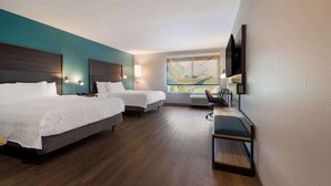 A hotel room with two beds, a desk, a chair, a TV, and a large window. - Tru By Hilton Novi Detroit (Novi)