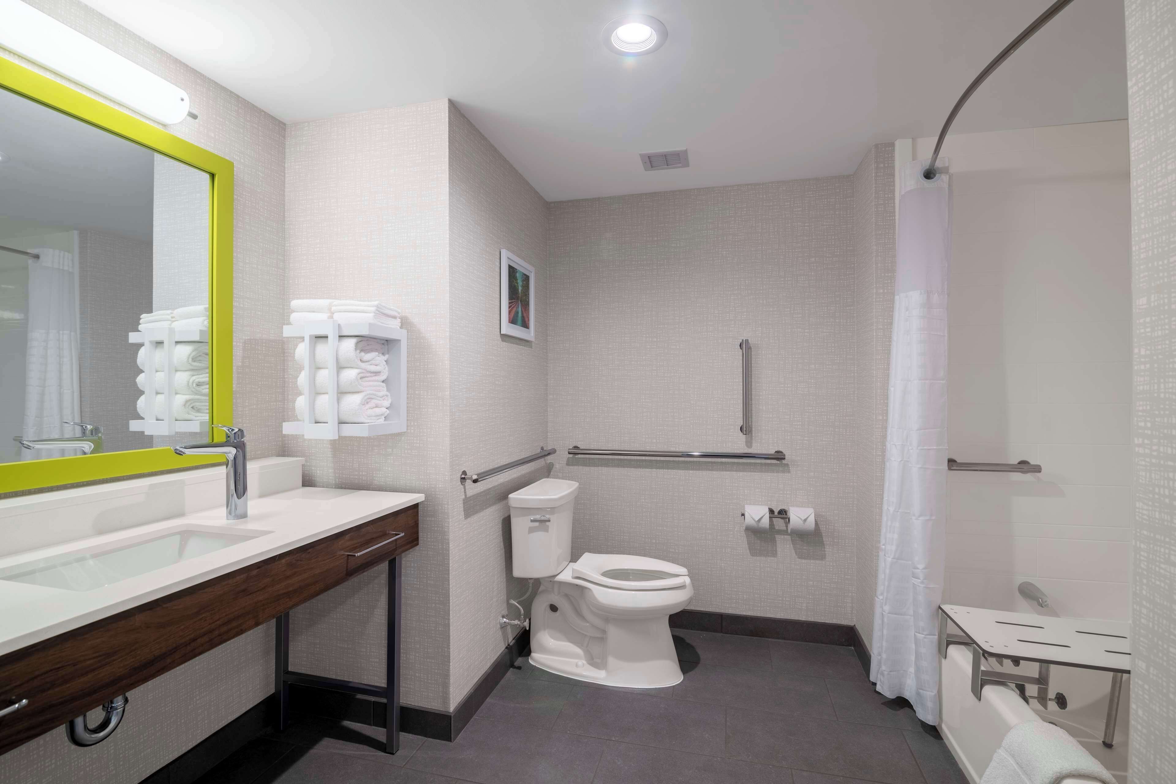 A modern bathroom with a sink, toilet, and shower area.