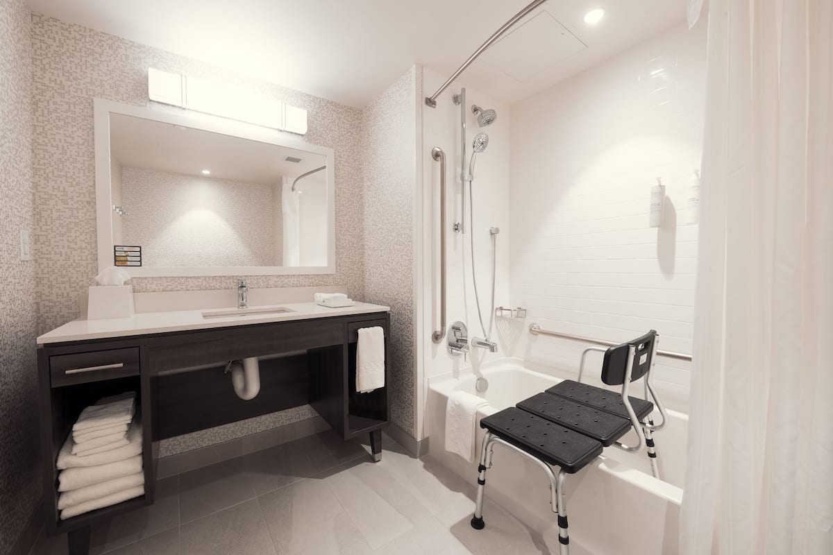 studio, 1 king bed, accessible, bathtub (mobility & hearing) | bathroom | rainfall showerhead, hair dryer, towels, soap