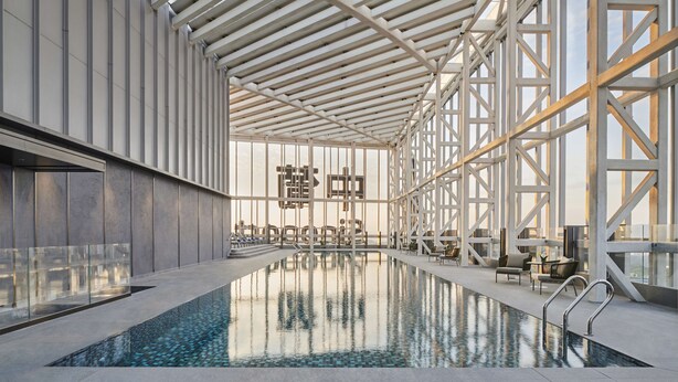 An indoor swimming pool with a high ceiling and large windows, surrounded by modern seating and a geometric wall design. - Doubletree By Hilton Zhuhai Hengqin (Zhuhai)