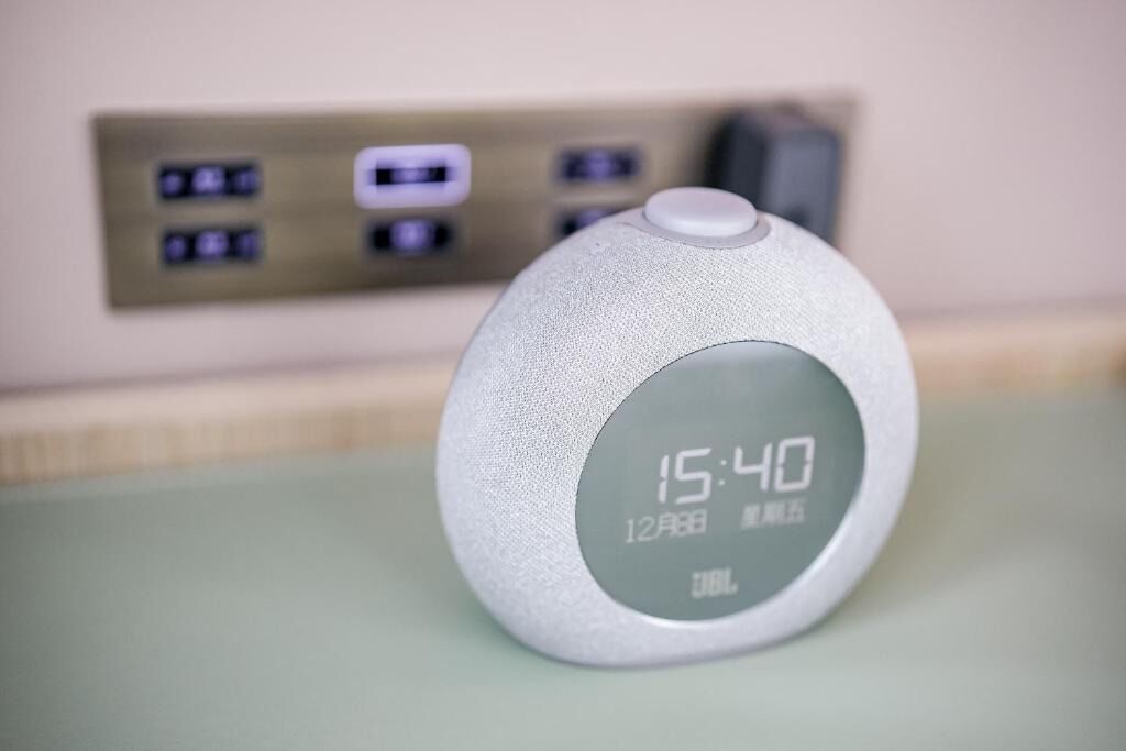 A digital clock displaying 15:40 on 12th August, with JBL branding.