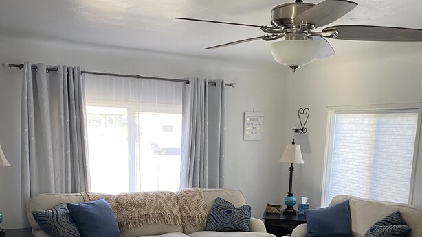 A living room with a beige sofa, a coffee table, and a patterned rug. - Comfy Bungalow (Lone Pine)