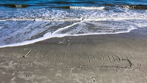 A beach with footprints and the words "Thanksgiving" etched in the sand. - Easy Beach Living – Single-Story Coastal Retreat - 5-Minute Walk to the Beach (Hilton Head Island)