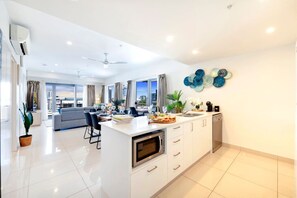 Fridge, coffee/tea maker, high chair, cookware/dishes/utensils - Reef-side Splendor: City Vistas ~ Pool ~ Workspace (Darwin City)