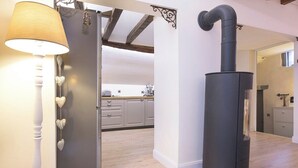 A modern kitchen with a built-in stove, wooden flooring, and a white wall. - Cocoon 1 min romantique (Annecy)