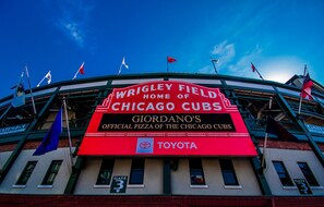A stadium with a sign for Wrigley Field, home of the Chicago Cubs, and a Toyota logo.