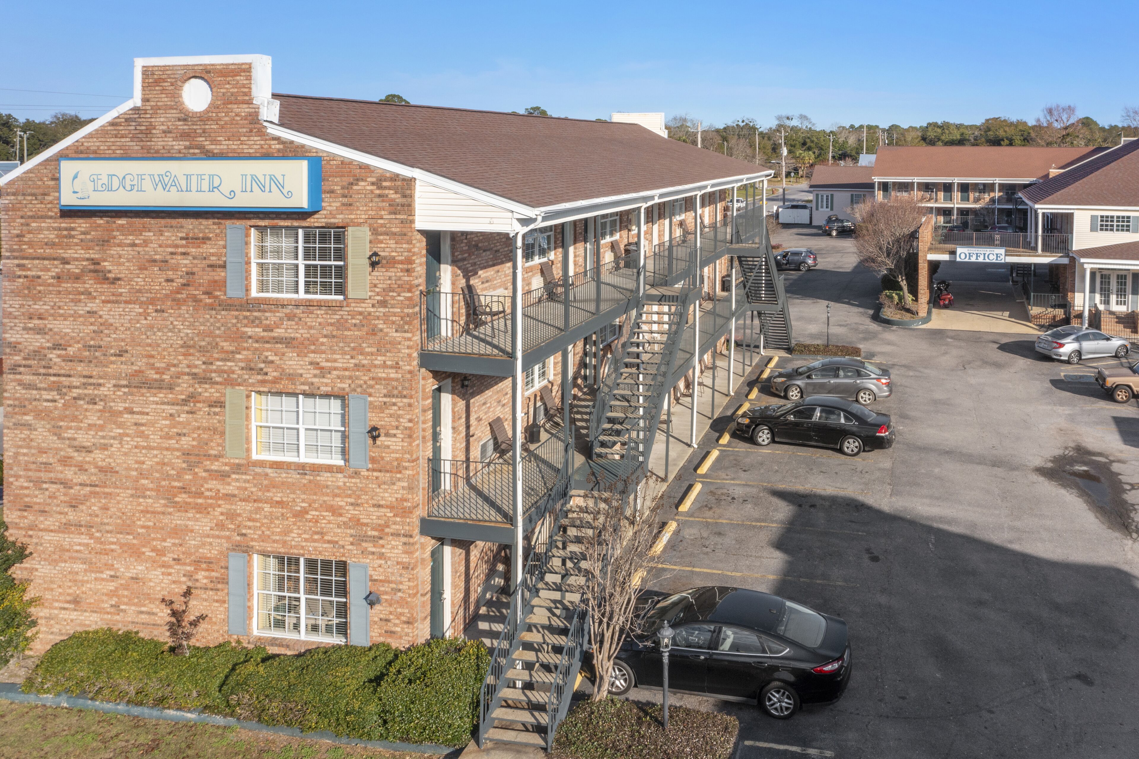 A two-story brick building with a sign reading "EDGEWATER INN".