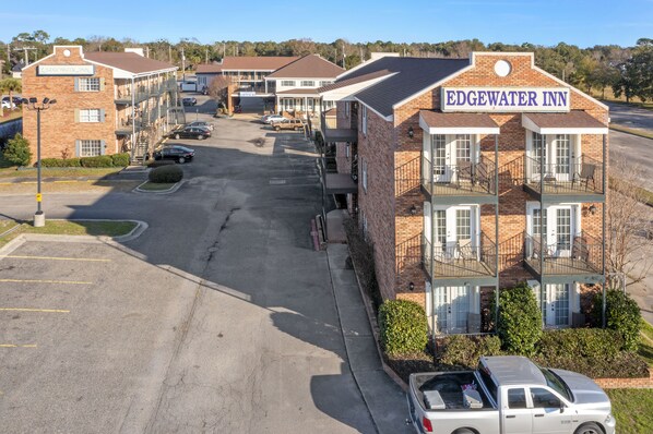 Edgewater Inn with a parking lot, multiple buildings, and a clear sky.