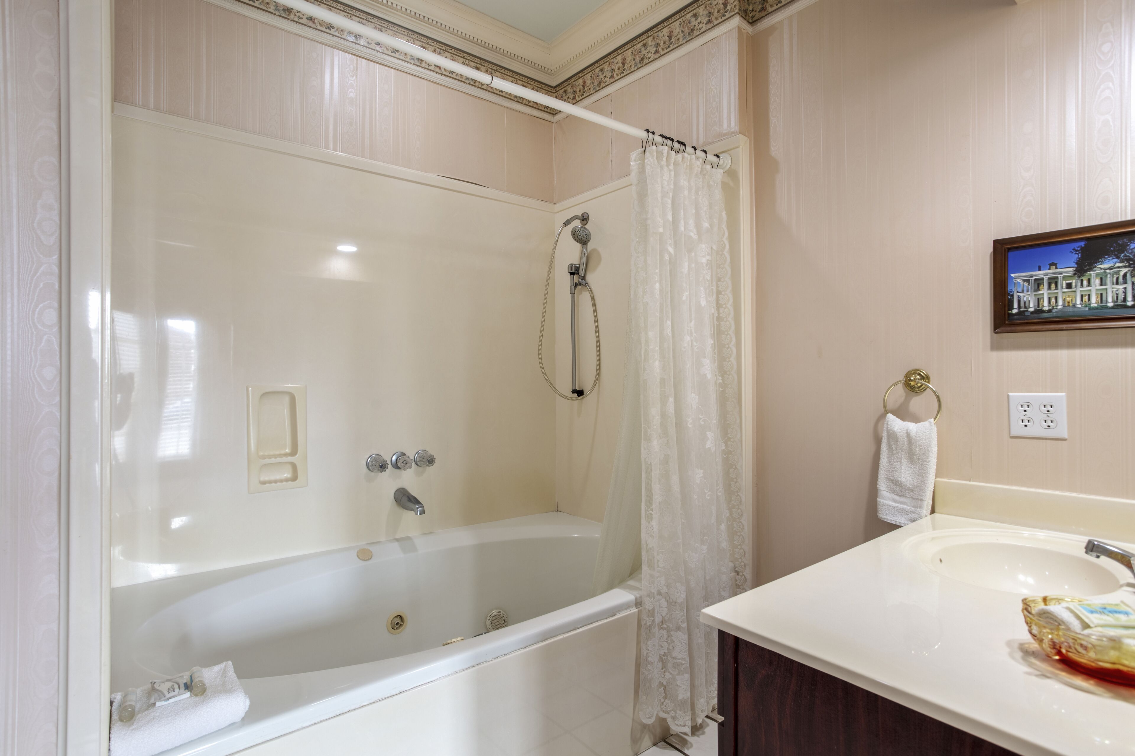 A bathroom with a bathtub, shower, and sink.