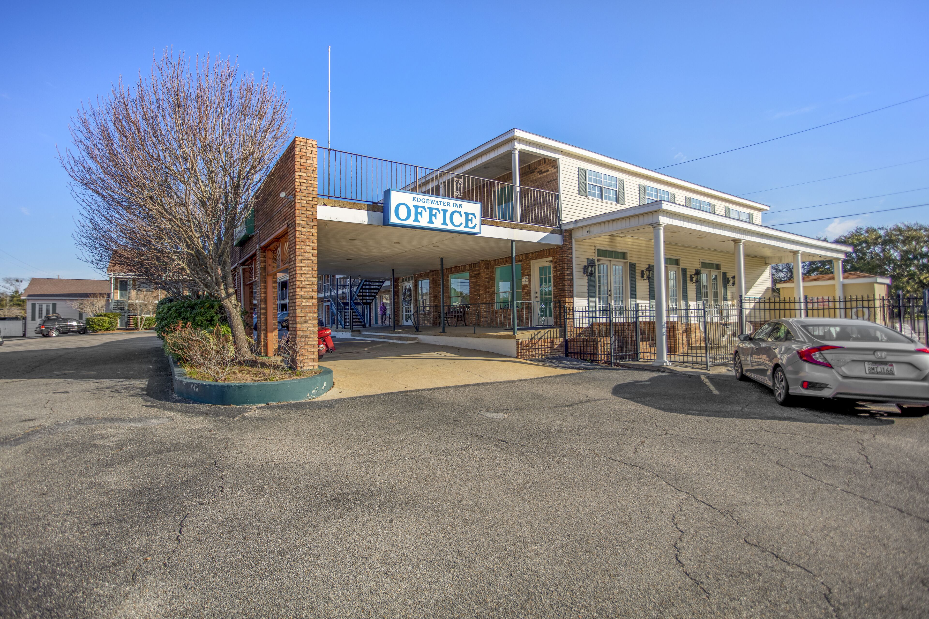 A two-story building with a sign reading "Edgewater Inn Office."