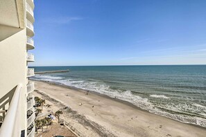 A beachfront hotel with balconies overlooking the ocean, a sandy beach, and a pier. - Oceanfront Myrtle Beach Condo w/ Balcony! (Myrtle Beach)