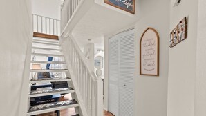 A staircase with white railings and wooden steps, leading to a room with a bed and a window. - 237 Beautiful deck view, close to strip and Marina (Branson)