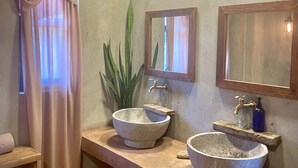 A bathroom with two stone sinks, a mirror, and a plant. - CASA TÚA, amazing views just minutes to the beach! (Puerto Escondido)