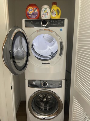 Convenient laundry facilities feature a front-loading washing machine with easy-to-use controls.