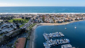 An aerial view of a coastal town with a marina, roads, and buildings. - Waterfront Condo w/ AC, BBQ, & Outdoor Living (San Diego)