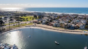 A coastal town with a marina, beachfront houses, and a clear view of the ocean. - Waterfront Condo | AC | Beach Toys | Walk to All! (San Diego)