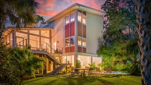 A modern two-story house with a covered patio, a staircase, and a pool. - Private pool, Luxury furnishings, Elevator, Short walk to beach & town (Folly Beach)