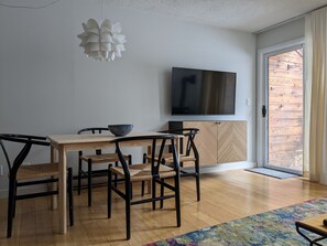 Enjoy meals in this dining area with a flat-screen TV, wooden table, and comfortable seating.