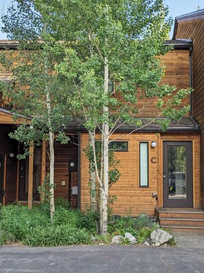 Step into a charming cabin with a prominent front door and beautifully maintained garden.