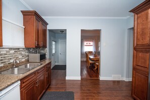 Enjoy cooking in this well-equipped kitchen with a microwave, stainless steel sink, and ample counter space.