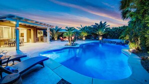 A swimming pool with lounge chairs and a covered patio area. - Flairbnb/Pool/Spa/Pool Table (Indio)