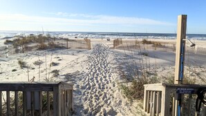 A sandy beach with wooden fences and a no beach access sign. - BEACHFRONT Townhome - New Kitchen and Bath - 2 BR 2.5 Bath   (Gulf Shores)