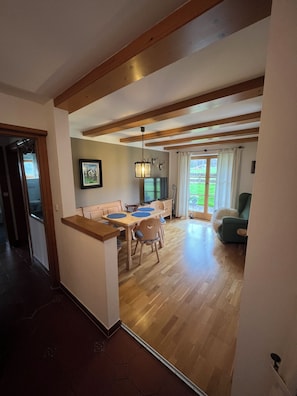 A modern interior with a dining area, a sofa, and a television. - Frühholz—The Vacation Home, 5-Star "Wank" Apartment in Grainau & Shared Garden (Grainau)