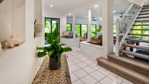 A modern interior with a staircase, white walls, and a potted plant. - The Palms - Hamilton Island (Hamilton Island)
