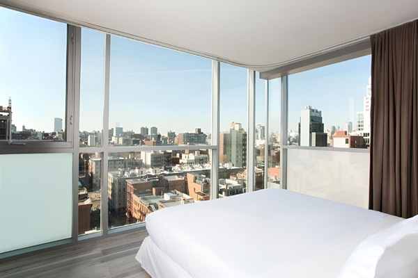 Wake up to sweeping skyline views from a cloud-soft bed.